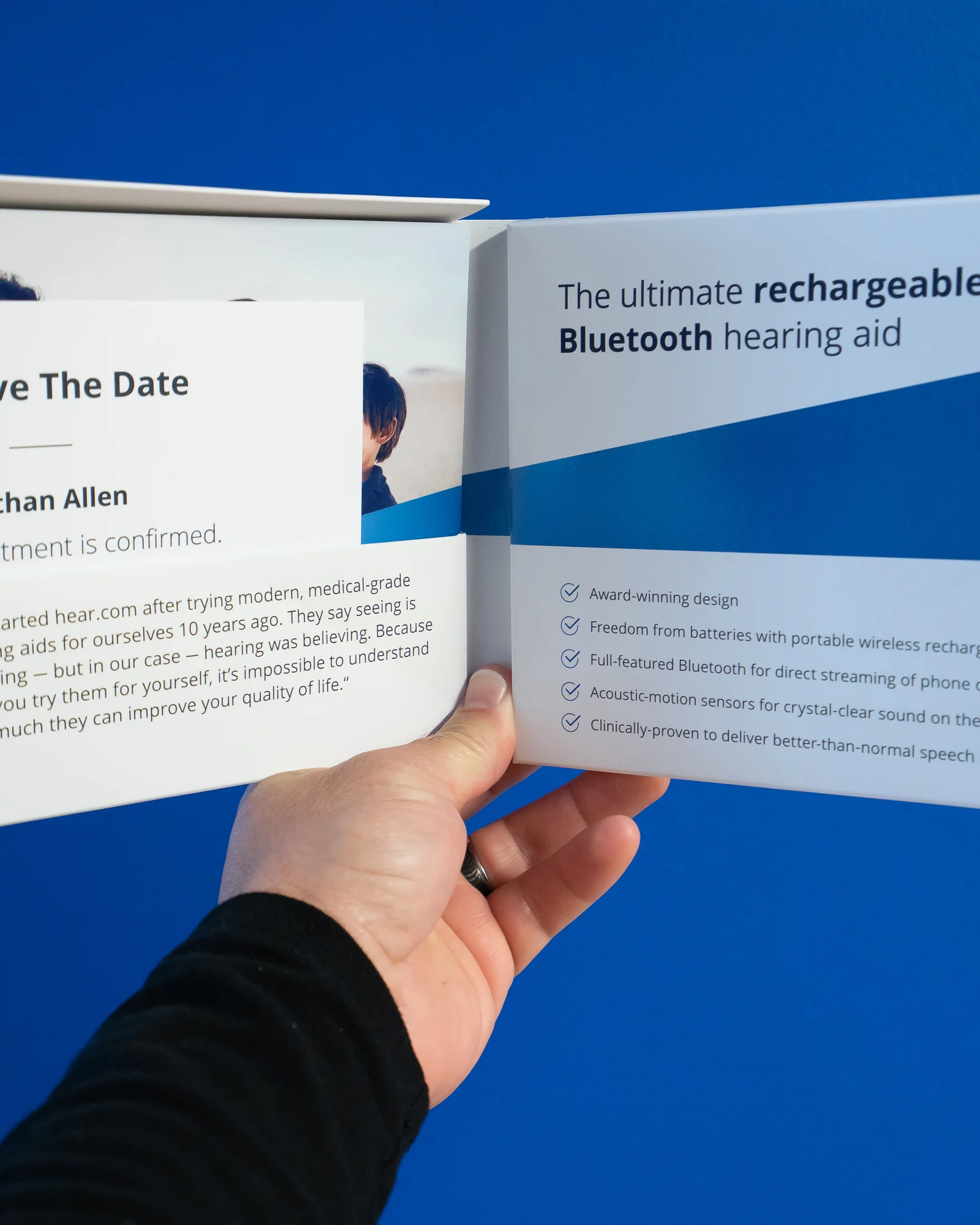 A hand holding the open hear.com appointment package